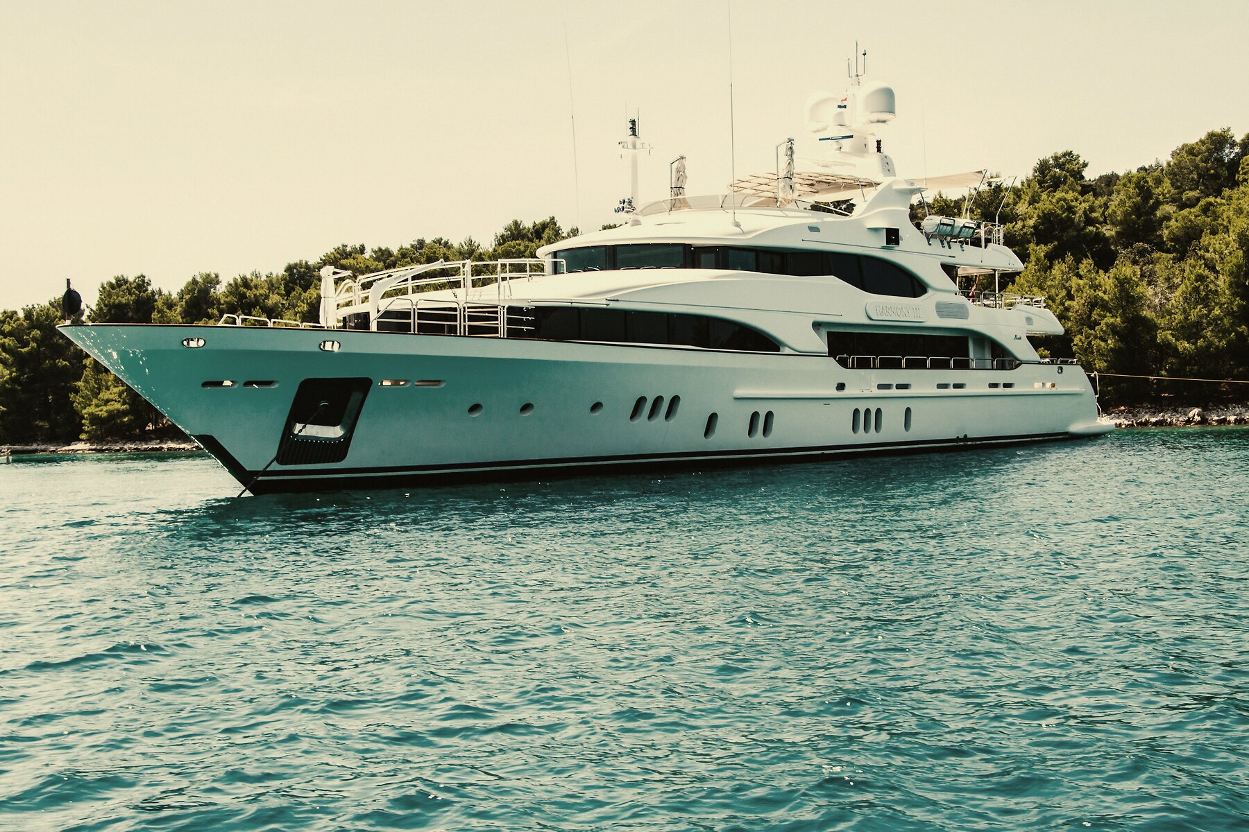 Premium motor vessel resting on calm water at golden hour